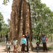Tess Atie with a family at termite mounds